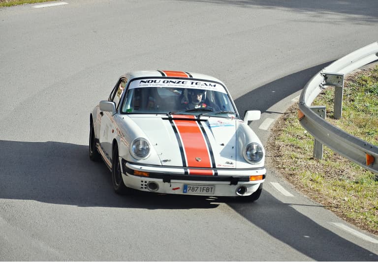 Porsche 911 driving on a mountain road