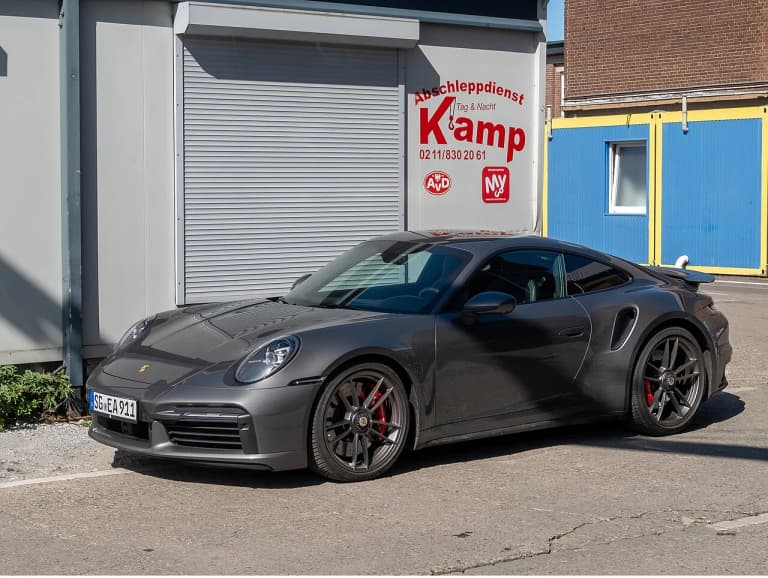 Grey Porsche 992 Turbo S parked on street