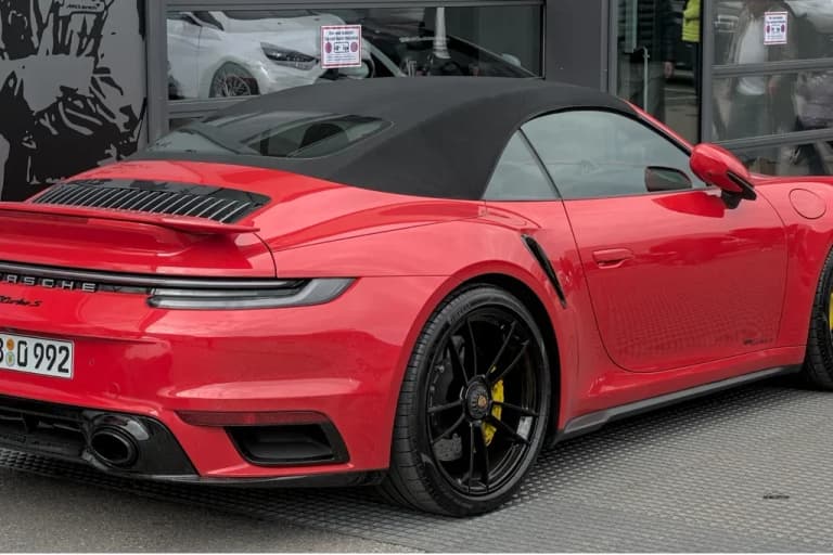 White Porsche 992 Turbo S Cabriolet with the roof down