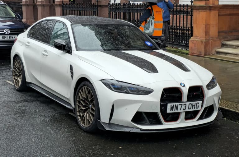 White BMW M3 CS (G80) with bronze wheels.