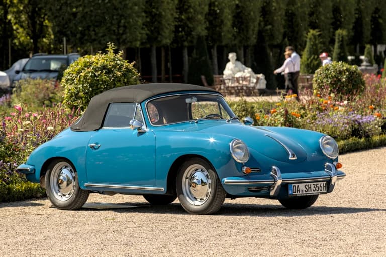 Light blue Porsche 356 B cabriolet parked in a formal garden