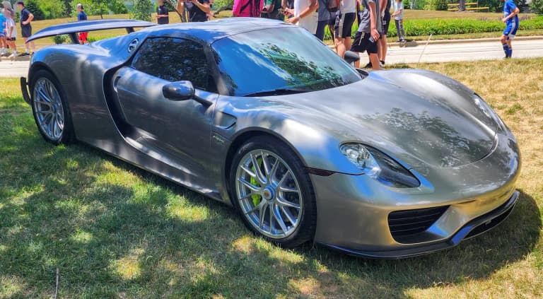 Dark grey Porsche 918 Spyder front three-quarter view at an outdoor car show