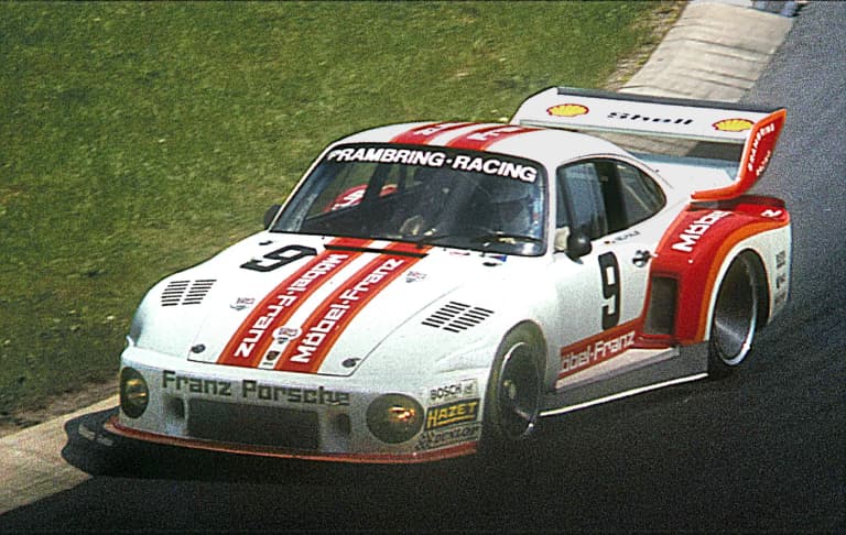 White number 9 Porsche 935 race car on track in period racing livery