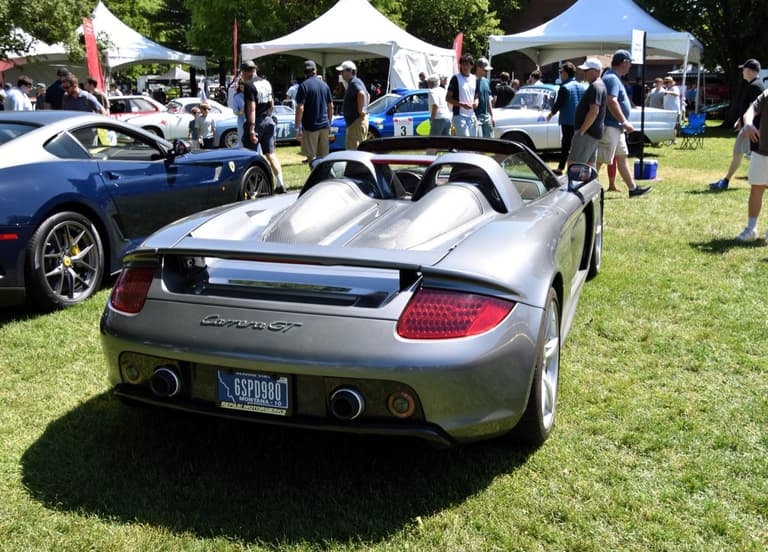 Rear three-quarter view of a silver Porsche Carrera GT showing the twin exhausts and rear deck