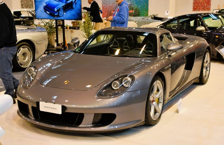 Grey Porsche Carrera GT shown from the front three-quarter with the roof in place