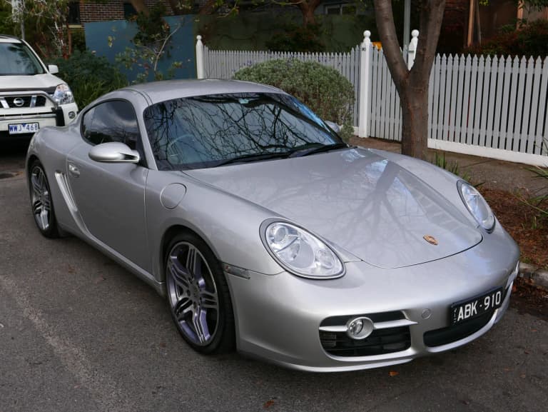 Silver first-generation 987 Porsche Cayman S coupe, three-quarter front view