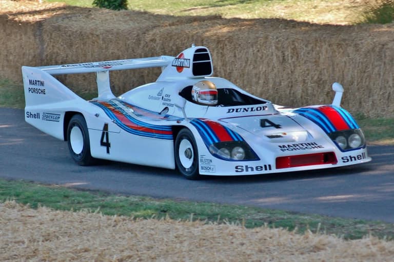Martini liveried Porsche 936 racing up the Goodwood hillclimb