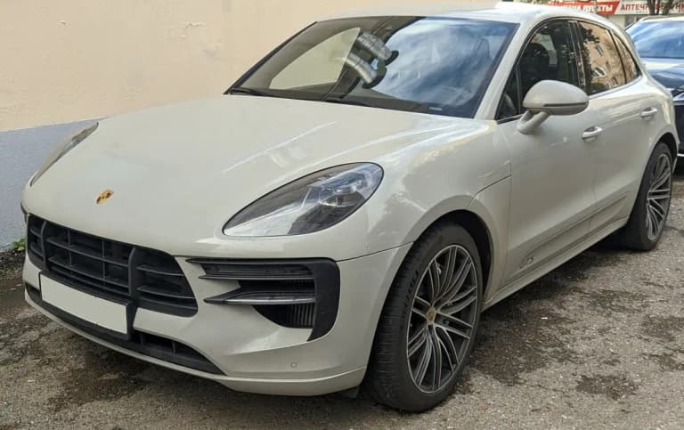 Crayon grey Porsche Macan GTS front three-quarter showing GTS badge on the door