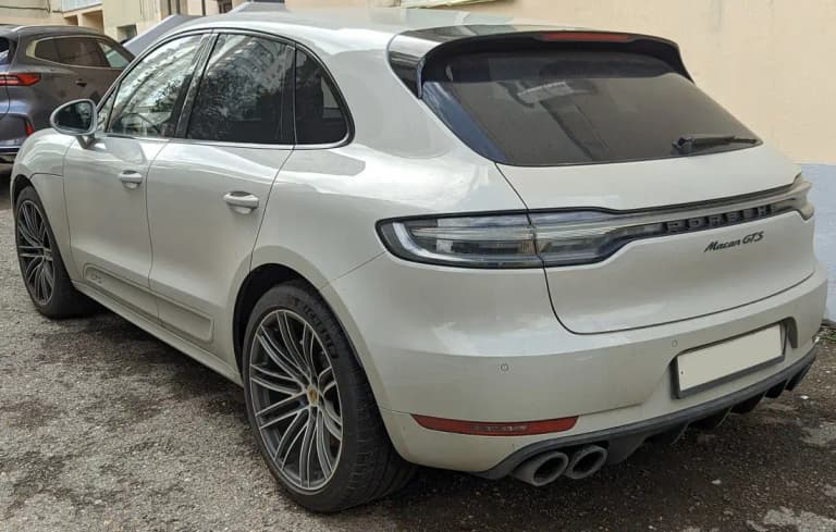 Crayon grey Porsche Macan GTS rear showing the center-mounted quad exhaust tips