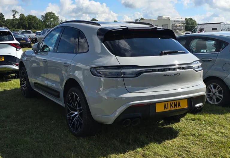 Grey Porsche Macan GTS rear three-quarter view showing the sport suspension stance