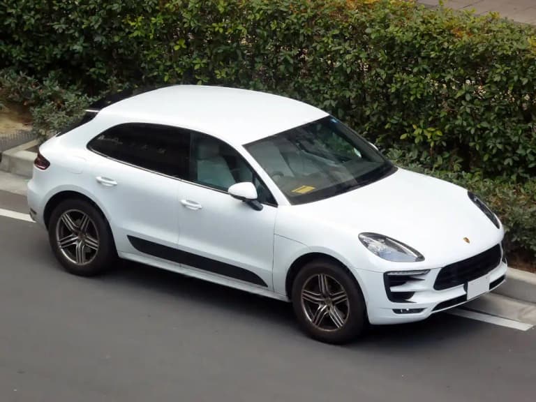 White first-generation Porsche Macan GTS front view with black side blades