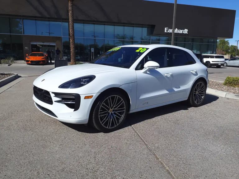 White Porsche Macan GTS front three-quarter view parked at a dealership