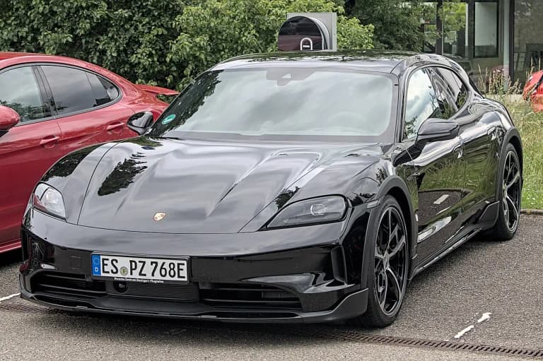Black 2024 Porsche Taycan Sport Turismo front three-quarter view