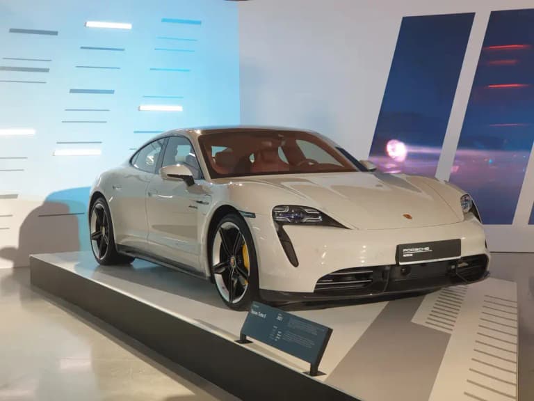 Chalk Porsche Taycan Turbo S on a Porsche Museum display stand