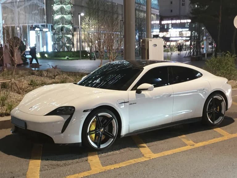White Porsche Taycan Turbo S parked on a street
