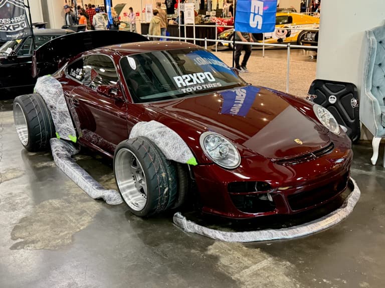 Maroon RWB Porsche 997 showing the riveted widebody fender extensions