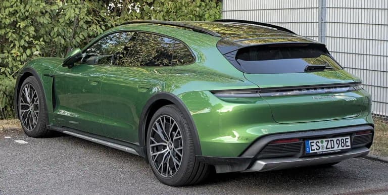 Green Porsche Taycan 4S Cross Turismo rear three-quarter view, the raised wagon body