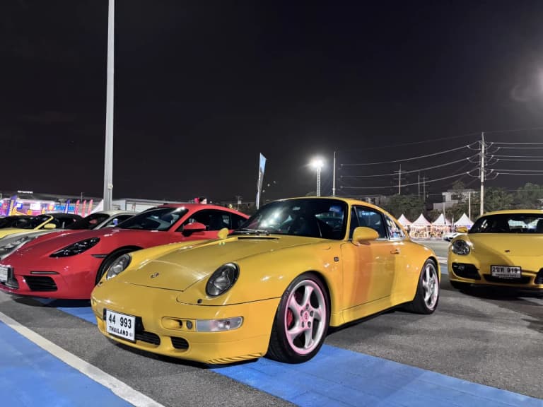 Yellow Porsche parked among Porsches gathered at Das Treffen X in Bangkok