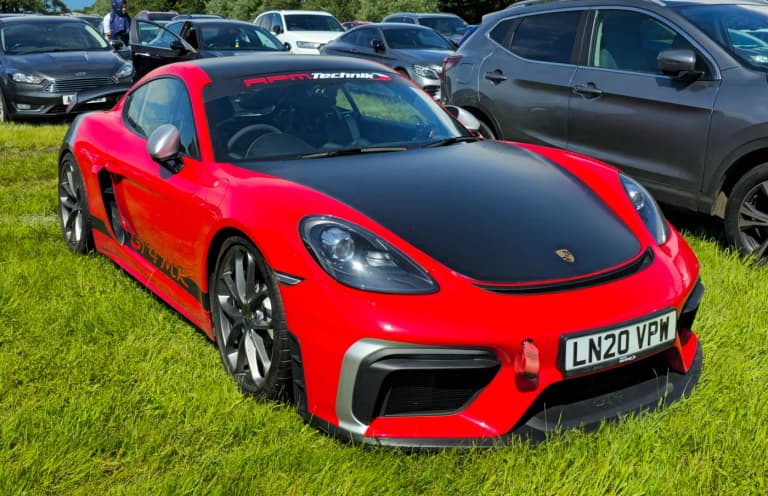 Porsche 718 Cayman GT4 in red, rear three-quarter view