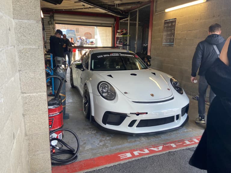 White Porsche 911 GT3 Cup race car in the pit lane