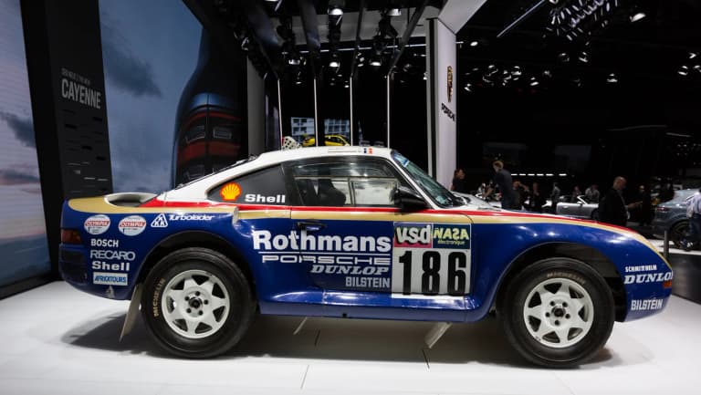 Blue and white Rothmans Porsche 959 Paris-Dakar rally car number 186 in profile