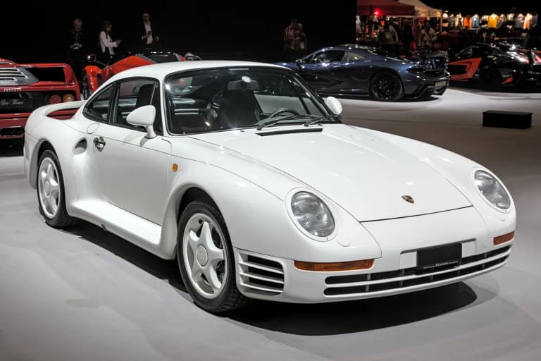 White Porsche 959 supercar on display at a motor show