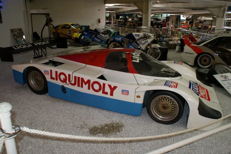 Red white and blue Liquimoly Porsche 962C side view in a museum