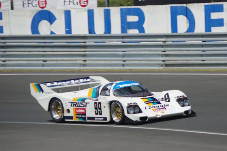 White Trust Greddy Porsche 962C number 99 on track at the Le Mans Classic