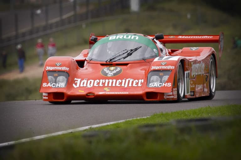 Red Jägermeister Brun Motorsport Porsche 962C racing on track
