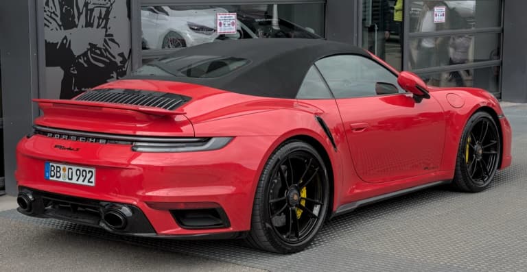 Red Porsche 992 Turbo S Cabriolet with soft top closed