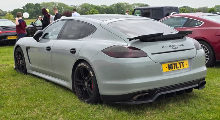 Gray first-generation Porsche Panamera 970 Turbo rear three-quarter view at a car meet