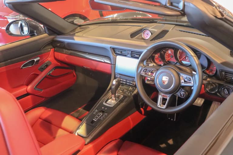 Porsche 911 cockpit showing the PDK gear selector and steering wheel paddle shifters