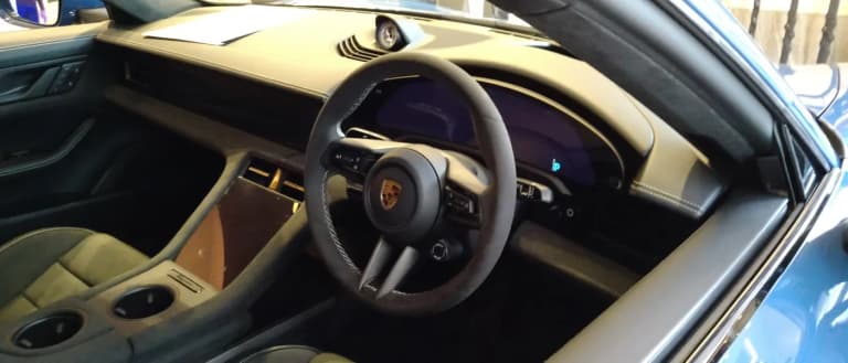 Porsche Taycan interior showing the curved digital cockpit