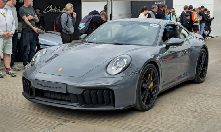 Grey Porsche 911 Carrera GTS 992.2 coupe, front three-quarter view with black wheels and 911 Carrera GTS front script