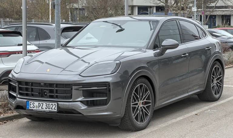 Gray Porsche Cayenne GTS Coupe, front three-quarter view with dark 21-inch wheels
