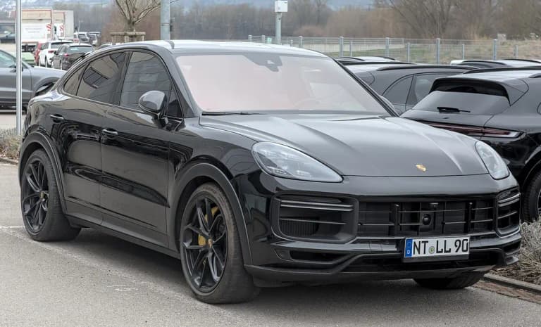 Black Porsche Cayenne Turbo GT, front three-quarter view with yellow brake calipers