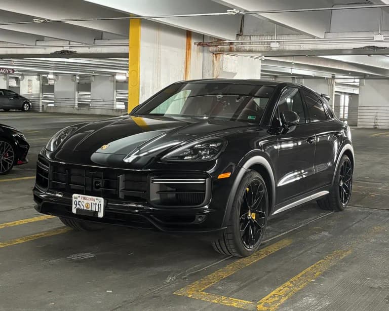 Black facelift Porsche Cayenne Turbo GT parked indoors, front three-quarter view