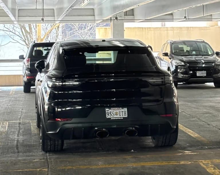 Black facelift Porsche Cayenne Turbo GT rear view with central titanium exhaust tips