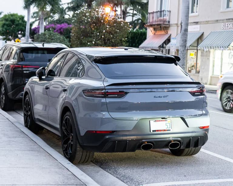 Gray Porsche Cayenne Turbo GT rear view showing central titanium tailpipes and diffuser