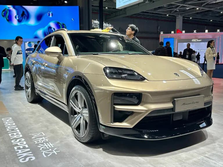 Gold Porsche Macan Turbo EV front three-quarter view