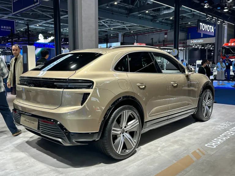Gold Porsche Macan Turbo EV rear three-quarter view