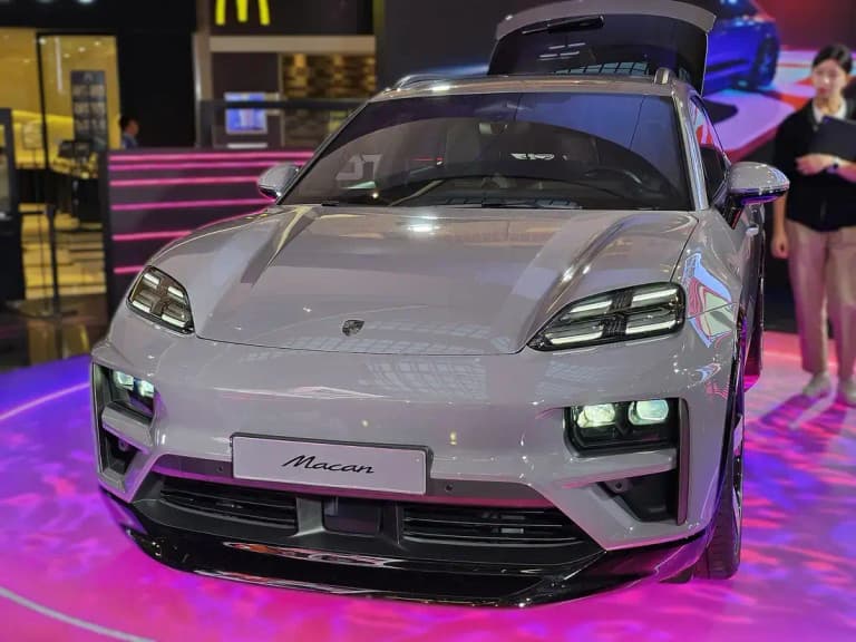 Gray Porsche Macan EV front view with four-point LED headlights
