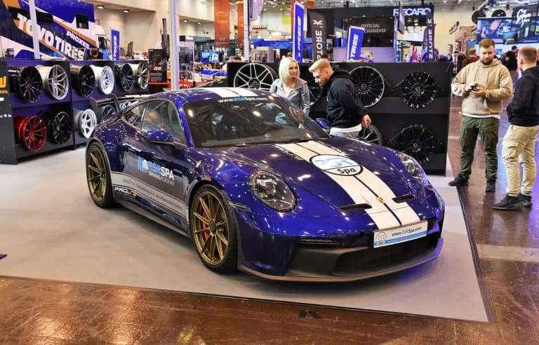 Blue Porsche 911 GT3 (992) on display at a motor show