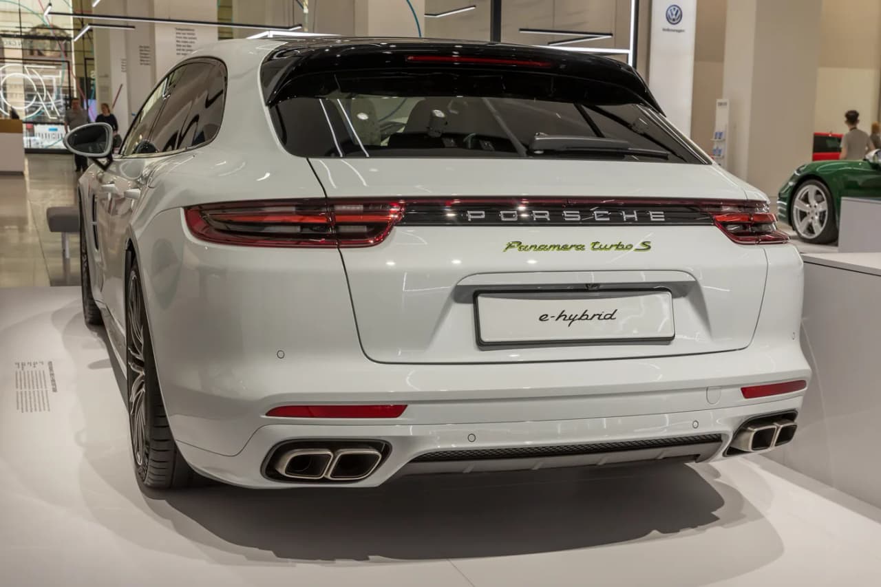 Rear view of a Porsche Panamera Turbo S E-Hybrid Sport Turismo showing its long roof, hatch, and adaptive roof spoiler