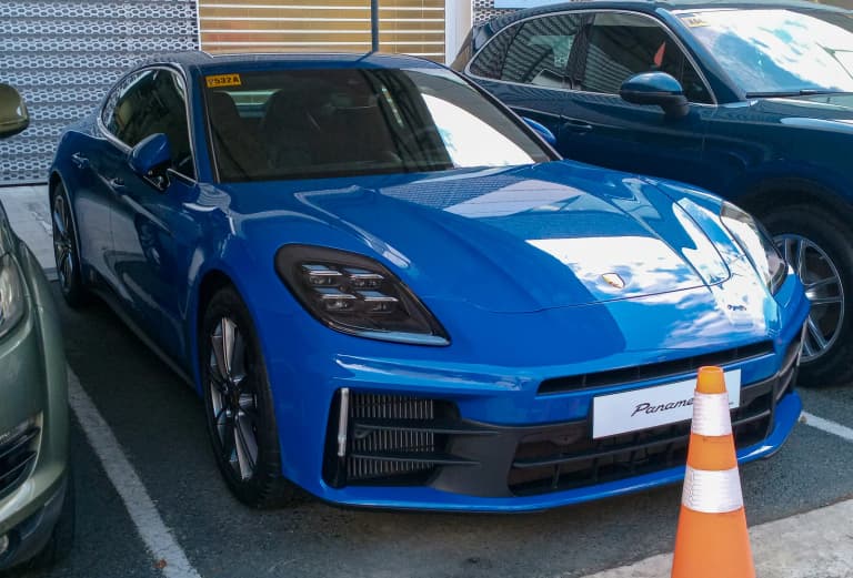 Blue 2025 Porsche Panamera, front three-quarter view