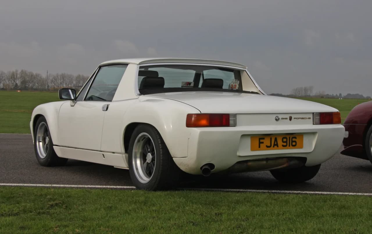 Rear three-quarter view of a white Porsche 916 showing its flared rear bodywork and molded rear fascia
