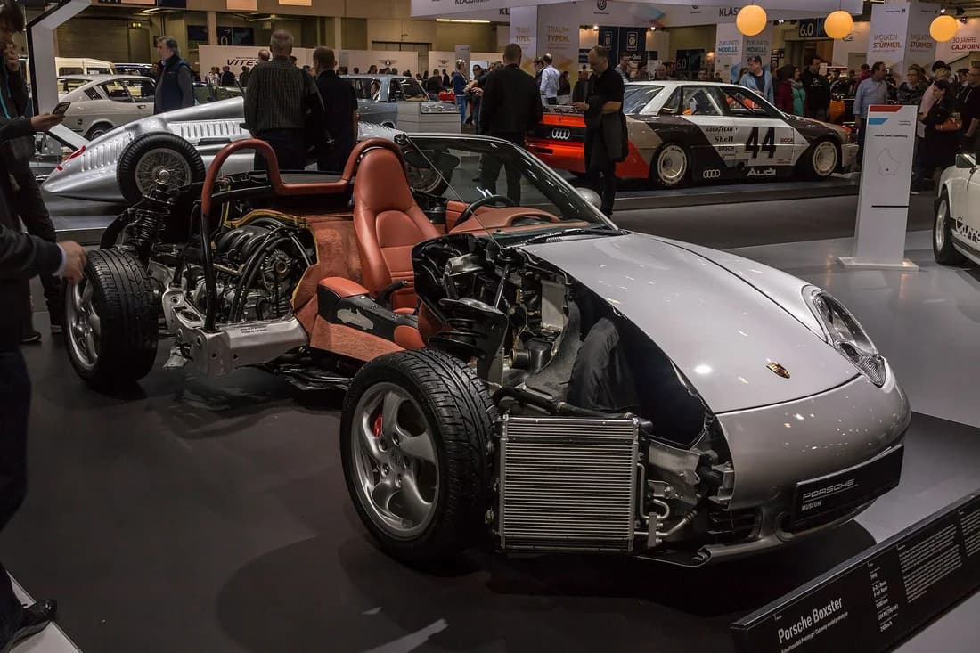 Porsche 986 Boxster museum cutaway showing its mid-engine layout, front cooling hardware, suspension, and service access