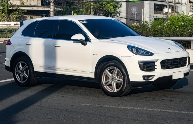 White Porsche Cayenne 92A Diesel, front three quarter view with diesel script badge on the front fender