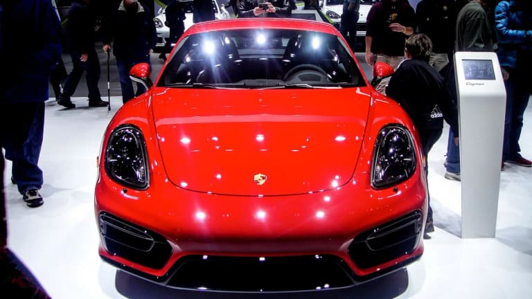 Red Porsche 981 GTS viewed from the front at an indoor motor show