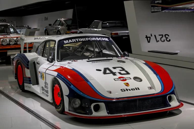 White and Martini-liveried Porsche 935/78 'Moby Dick' race car on display in the Porsche Museum